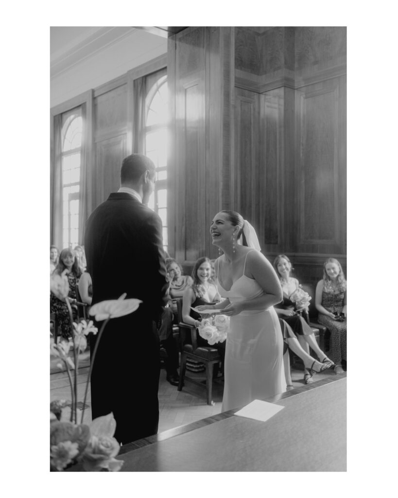 Bride laughing during her ceremony. Black and White classic image with a vintage feel bringing out all the emotion. Photo by London Wedding Photographer, Pia Bacino