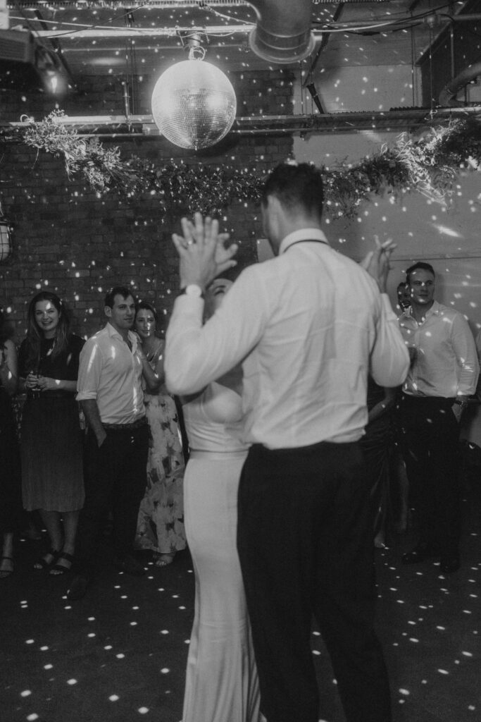 Couple dancing on their wedding day while their guests watch in awe. Photo by London Wedding Photographer, Pia Bacino